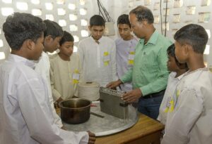 Boys learn  the basics of candle making.