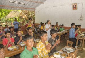 Prayer before group lunch.