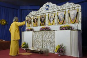 Brahmachari Dhairyananda performs aarti before evening meditation.