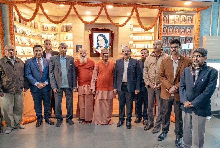 Swamis Nityananda and Smaranananda (centre) with railway officials and devotees.