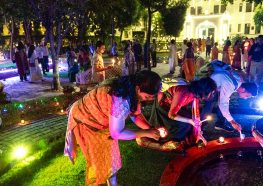 Devotees lighting candles in Noida.