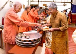 Monastics serve prasad.