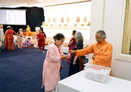 Swami Lalitananda distributes prasad after the programme.