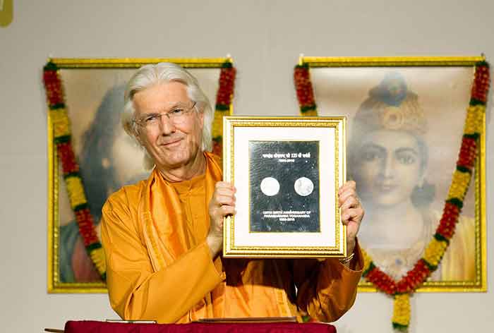 Swami Chidananda launching the Commemorative Coin