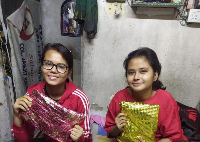 Noida Support Seva Activity 2021 Girls show their gifts received from a YSS volunteer.